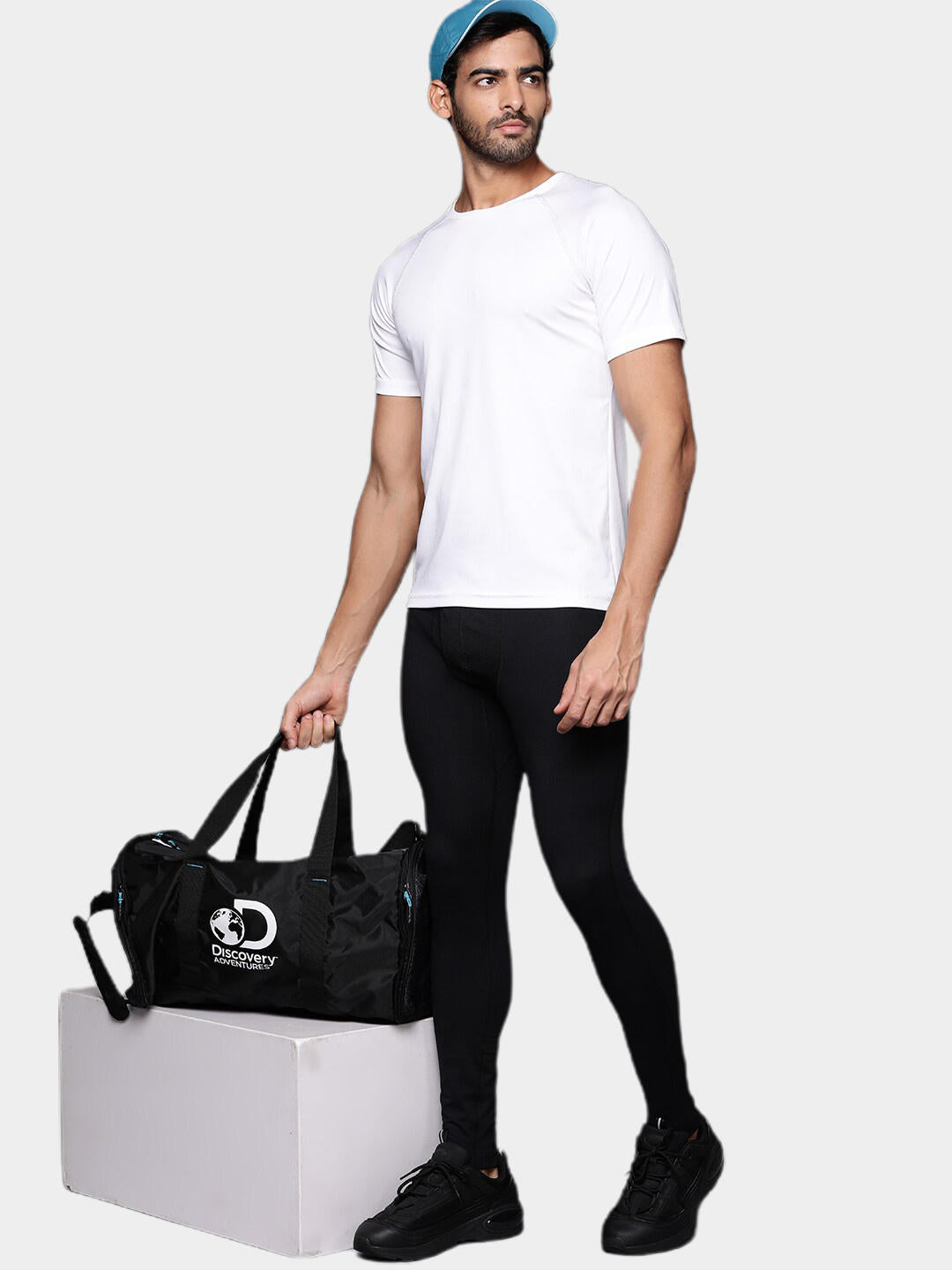 A man wearing black heavyweight thermal bottoms standing against a white background.