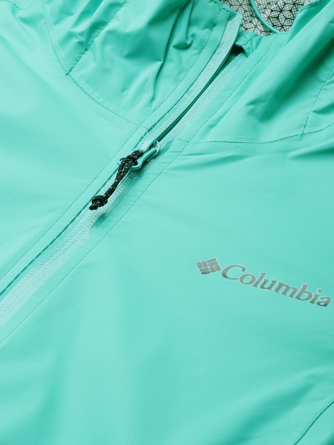 A Women Wearing Columbia Women Green EvaPOURation Jacket Waterproof