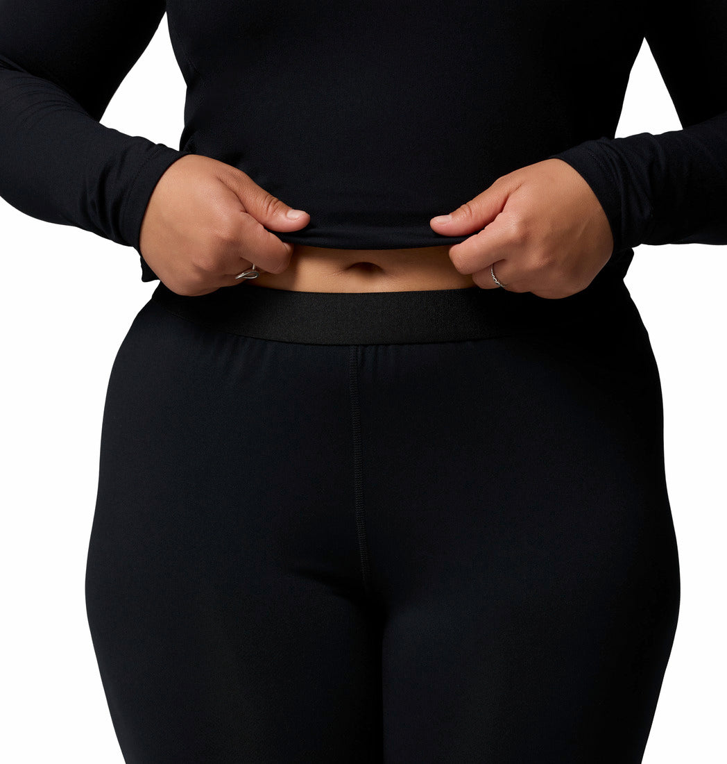 Person wearing black leggings on a white background