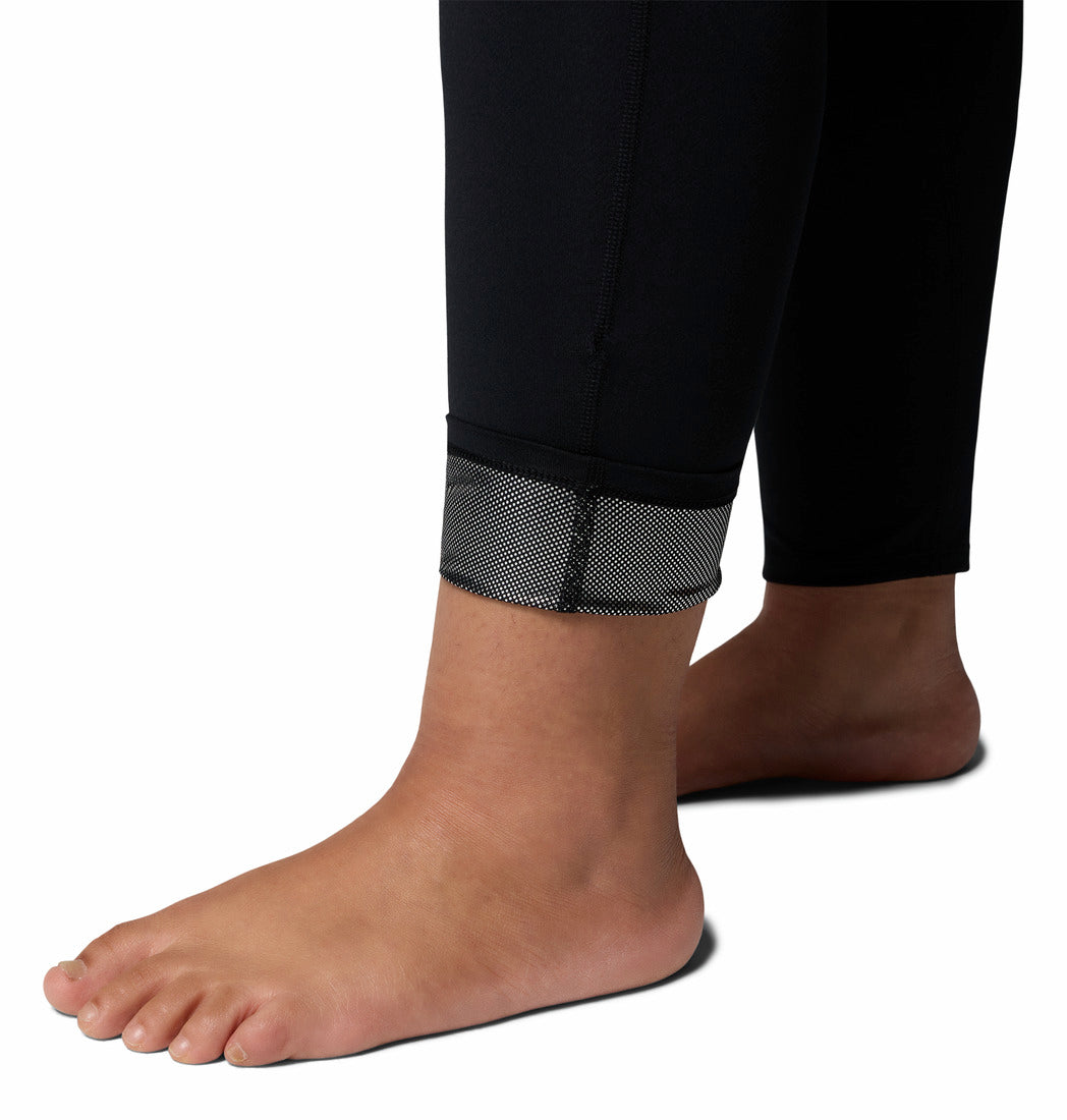 Person wearing black leggings on a white background