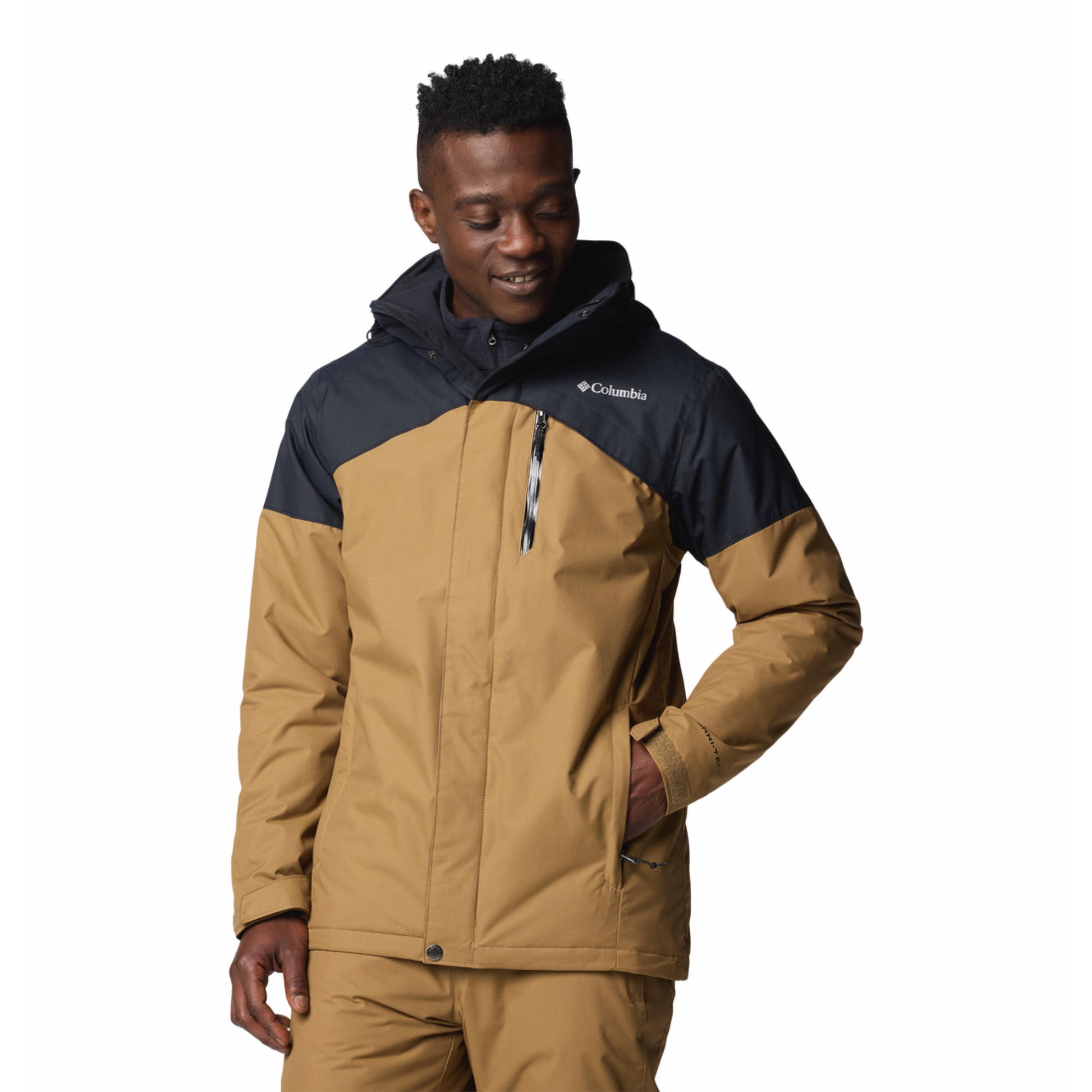 Man wearing a brown and navy Columbia jacket on a white background